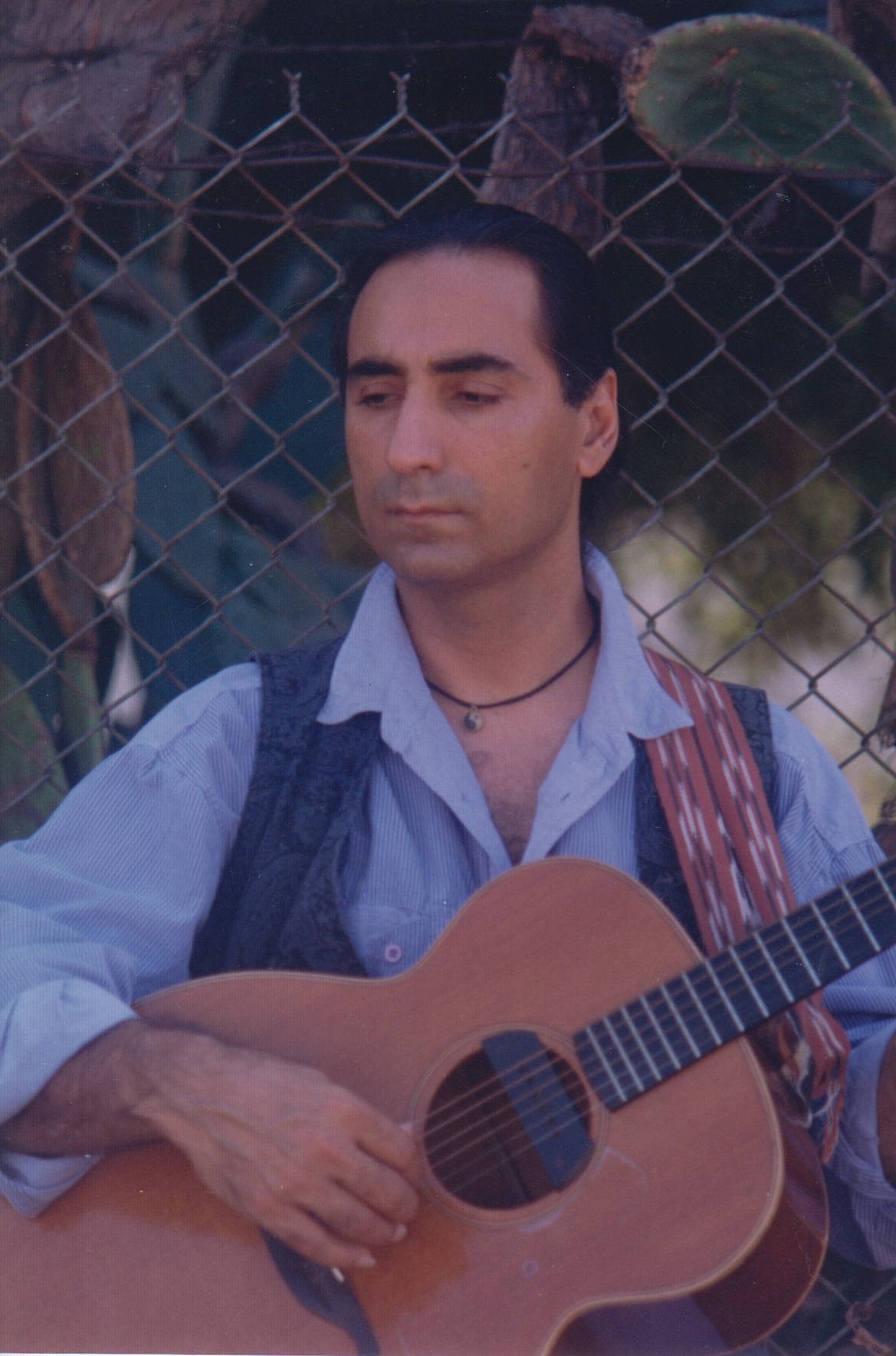 Aldoush playing acoustic guitar